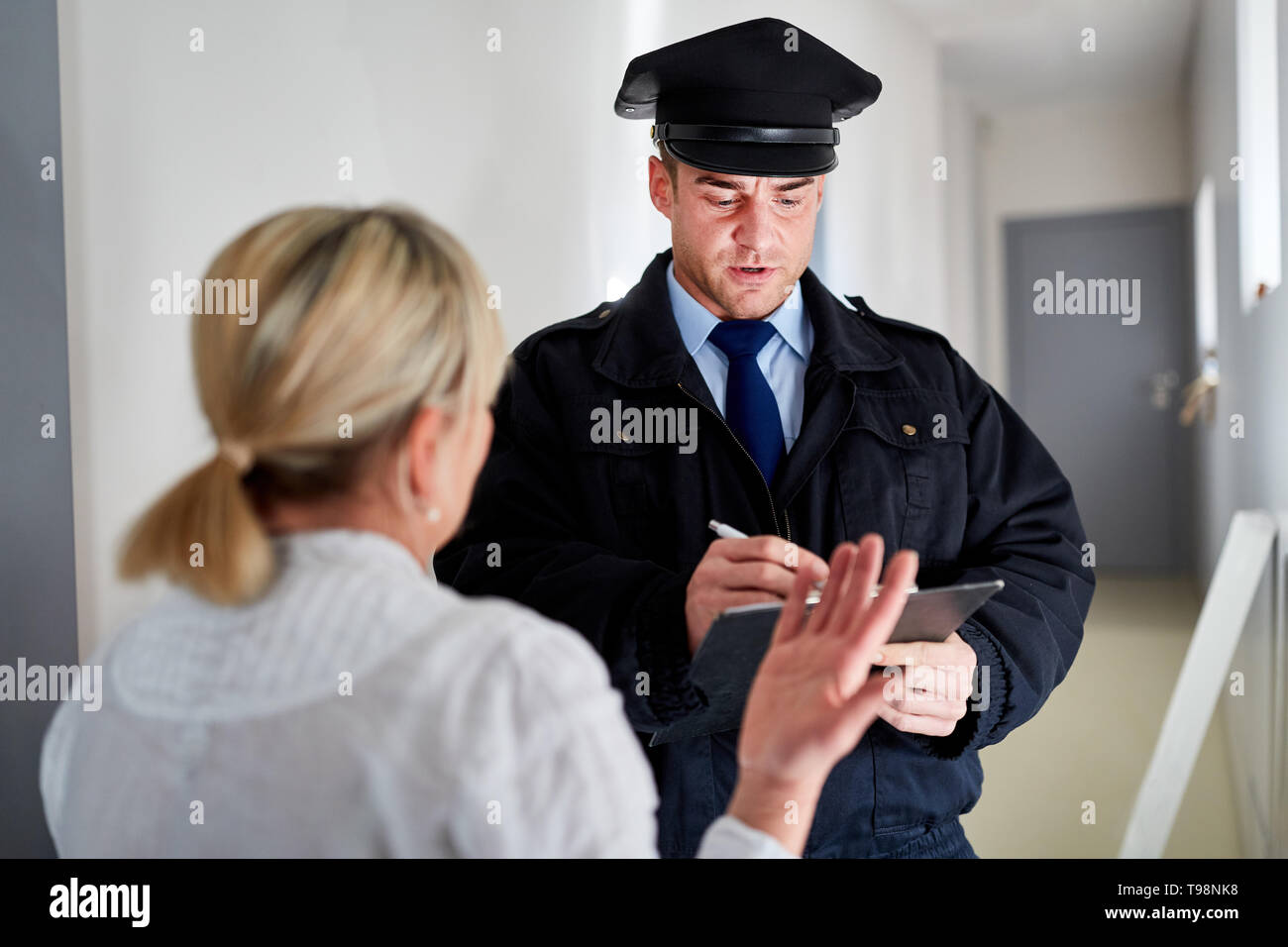 Polizist macht Zeugnis Interview nach Einbruch und Gespräche mit Zeugen Stockfoto