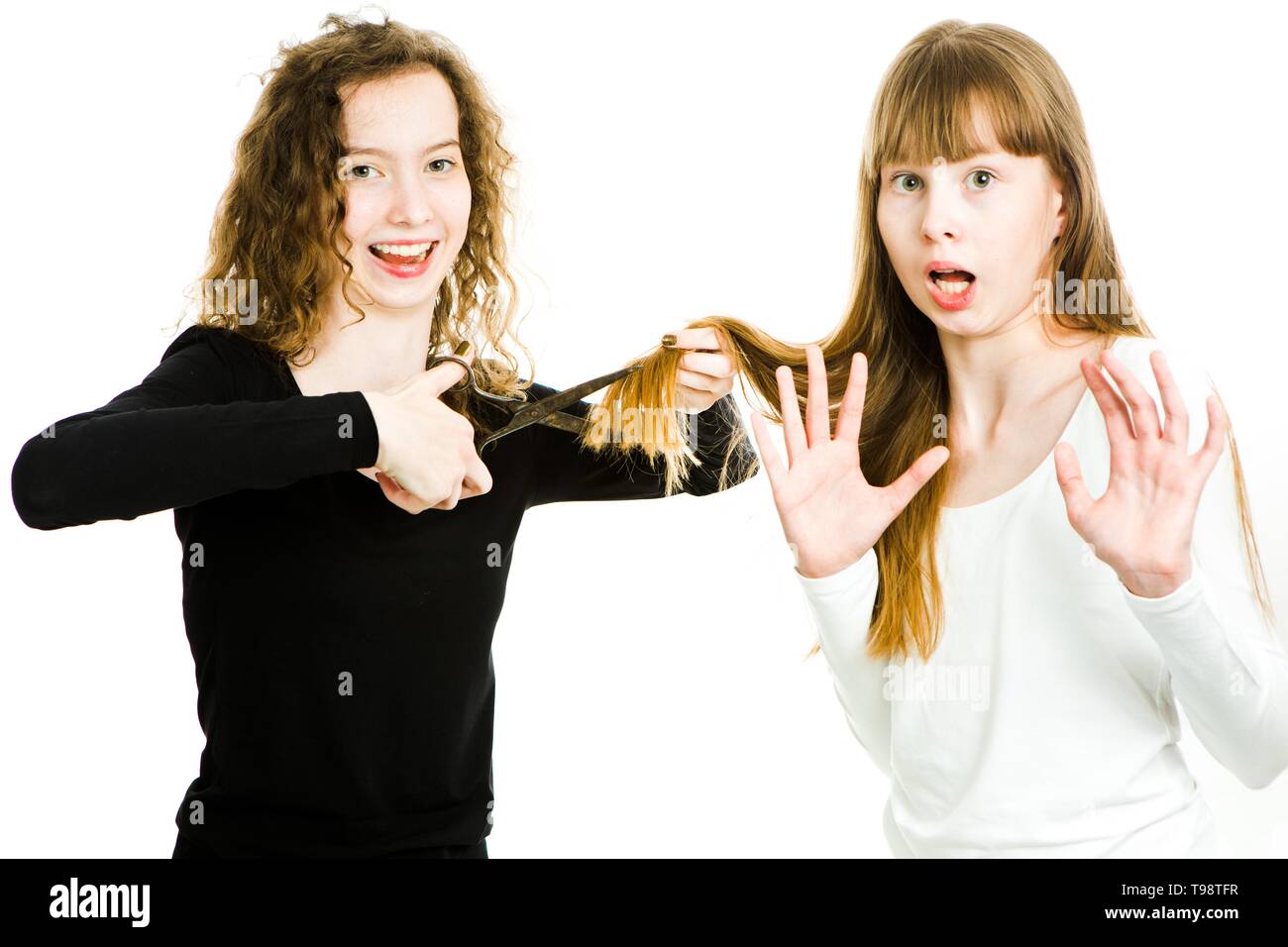 Zwei Mädchen mit blonden Haaren und Schere, man um Haare besser Haarschnitt, den Schnitt, die zweite Macht Geste der widerstehen - junge Friseur-weiß Ba Stockfoto