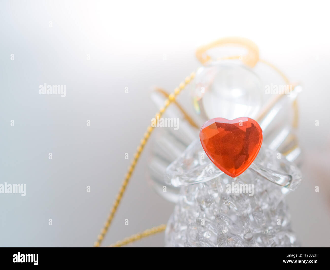 Glasengel-Statuette mit Herz Stockfoto