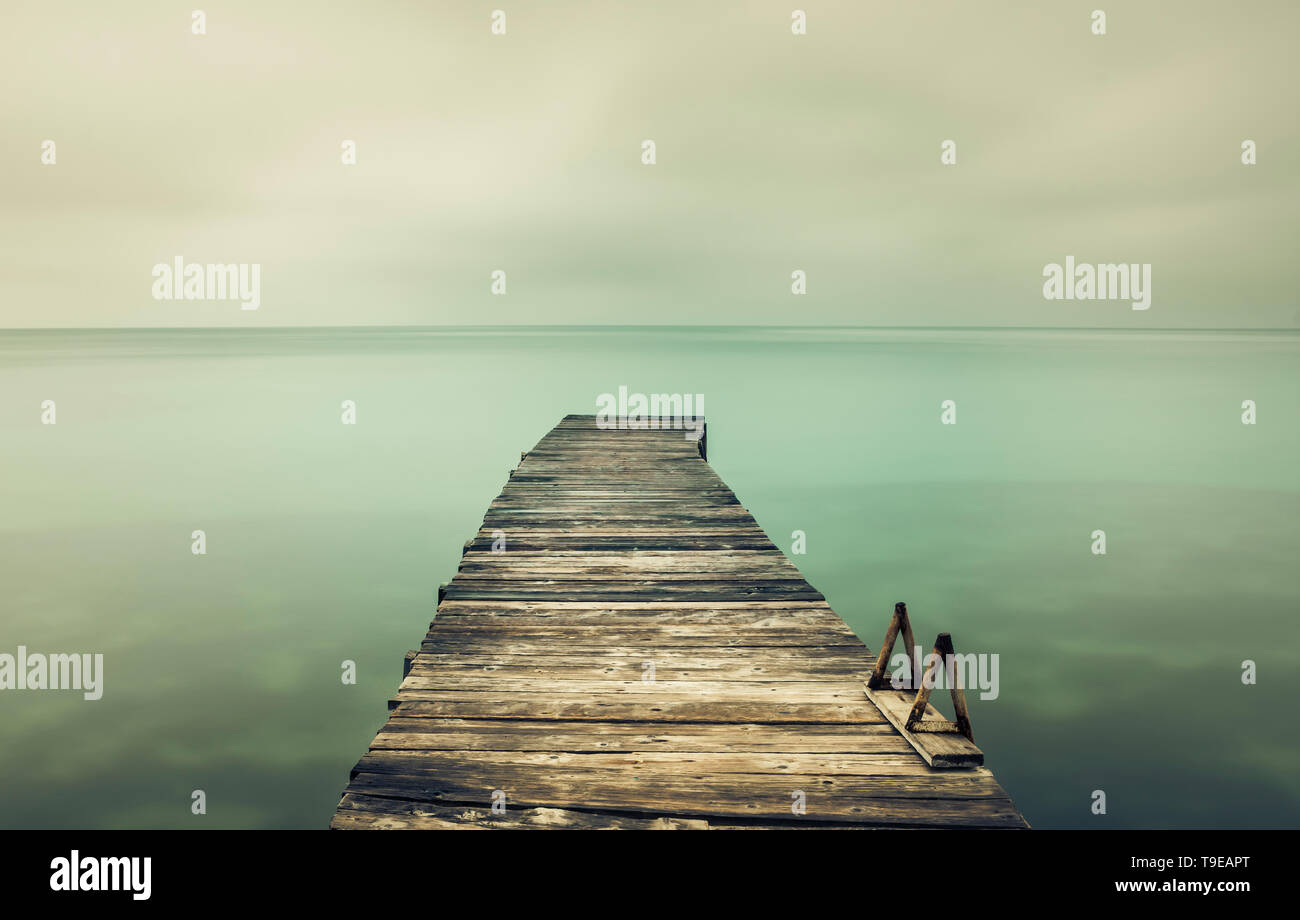 Lange Exposition von einem Pier in South Corfu Griechenland. Bewölkter Himmel. Stockfoto