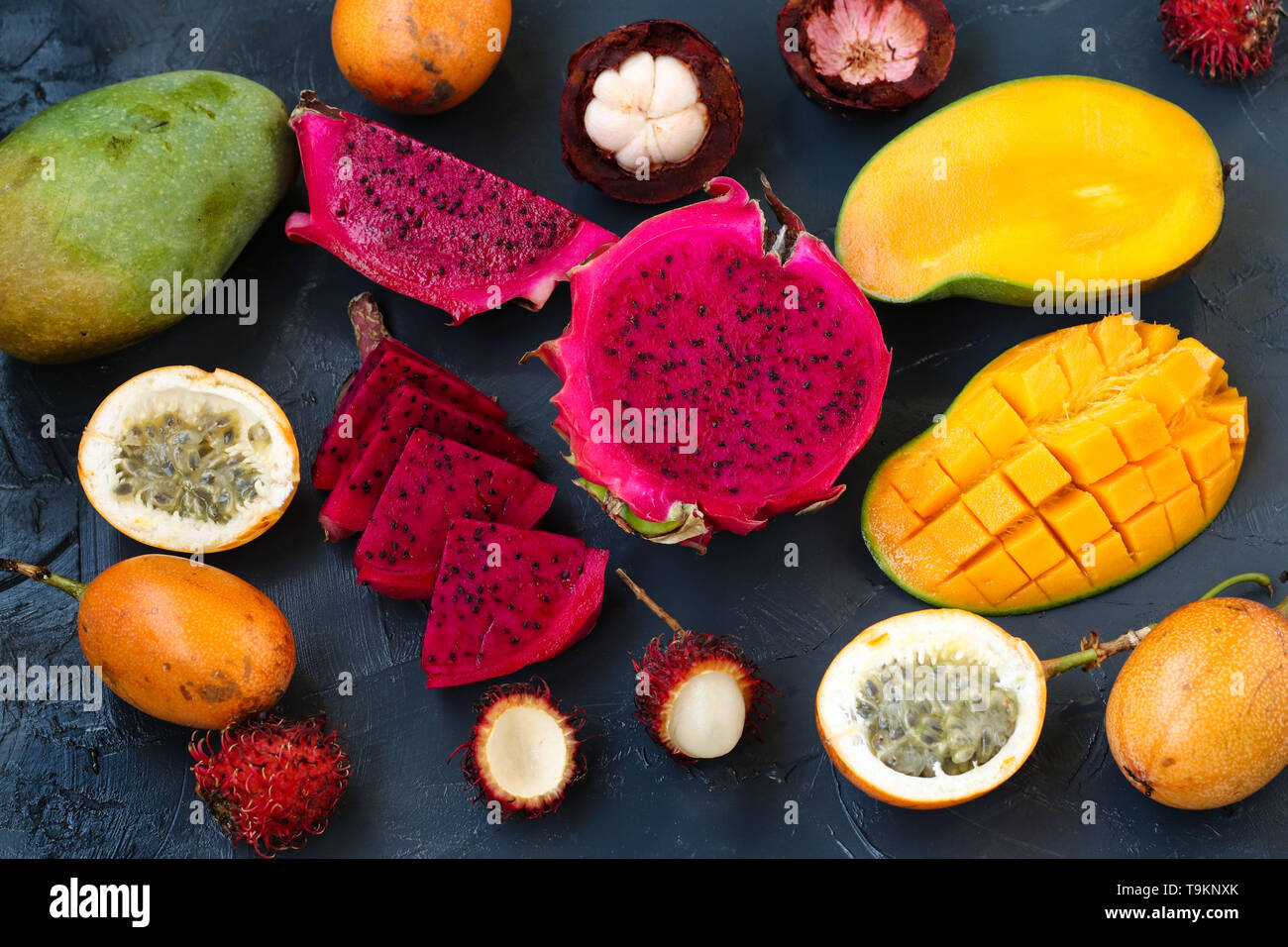 Tropische Früchte: dragon Obst, Passionsfrucht, Mangosteen, Rambutan und Mangos sind auf einem dunklen Hintergrund entfernt Stockfoto