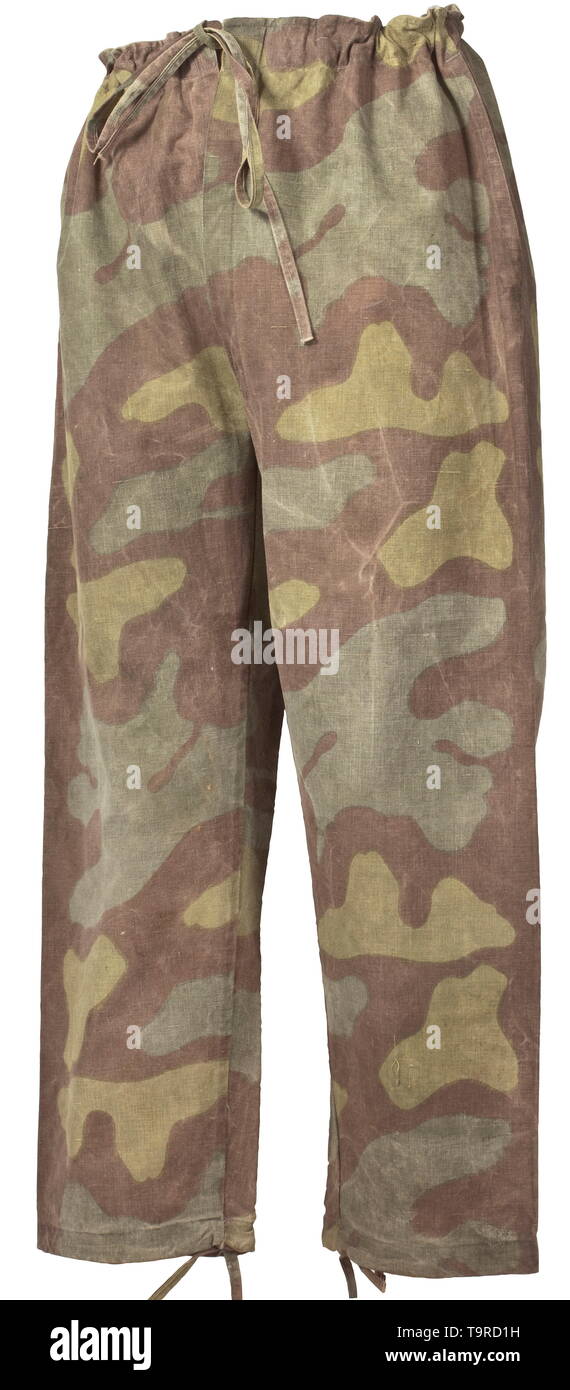 Ein paar overtrousers in Italienisch Tarnmuster Einfache, aber professionelle Produktion durch ein Feld mit Schüttgut mit einer Seite in Camouflage Muster. Ziehen Schließung Schnüre an der Taille und am Bein Terminals, zwei Reach-in-taschen Nähte. historischen, historische, 20. Jahrhundert, Editorial-Use - Nur Stockfoto