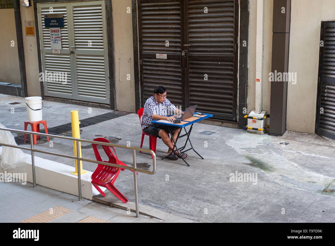 09.05.2019, Singapur, Republik Singapur, Asien - ein Mann in Chinatown sitzt an einem Schreibtisch arbeiten auf seinem Laptop. Stockfoto