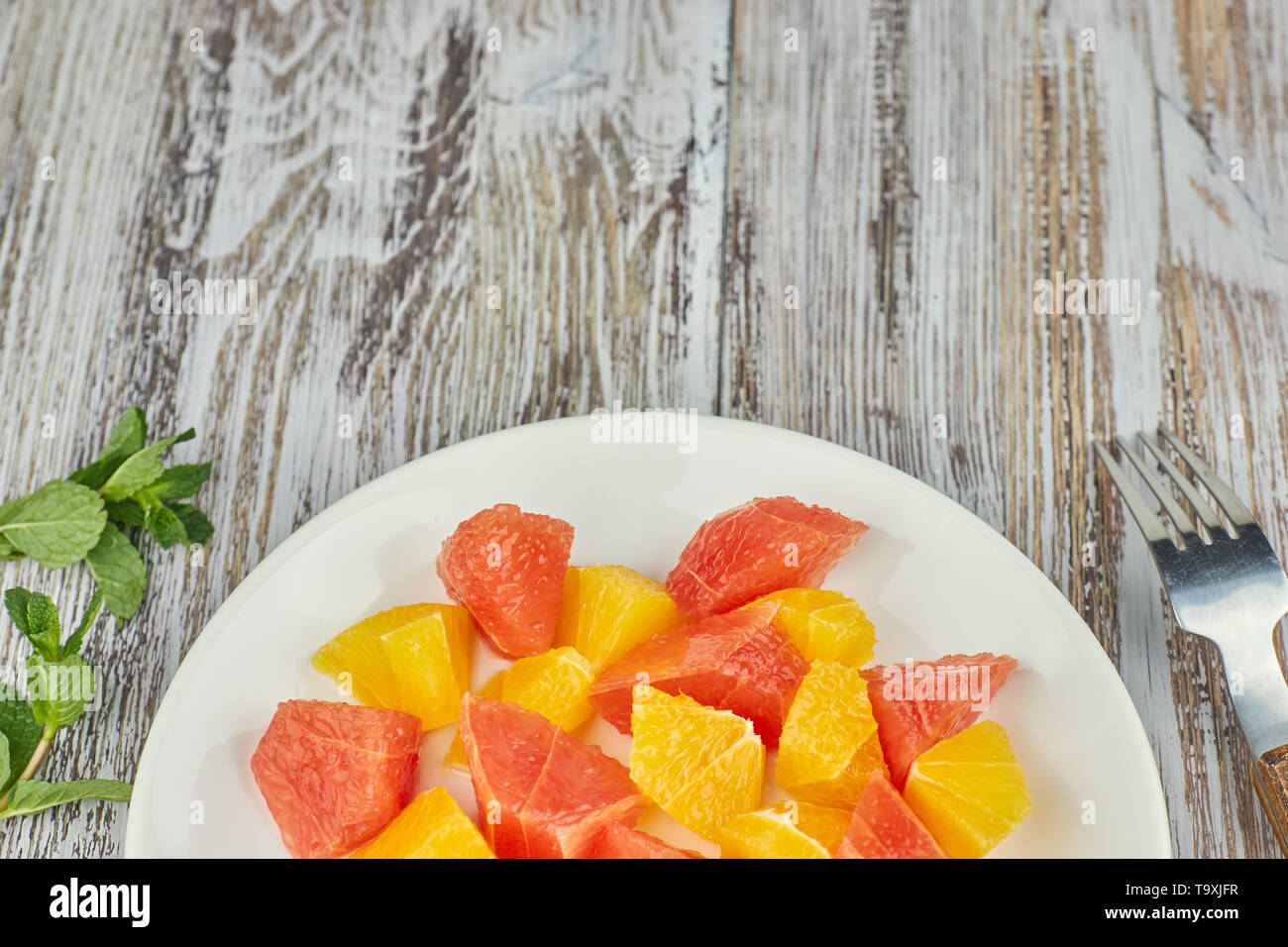 Citrus detox Salat. bunten tropischen und Zitrusfrüchte auf einer Platte geschnitten. Landhausstil. kopieren. Stockfoto