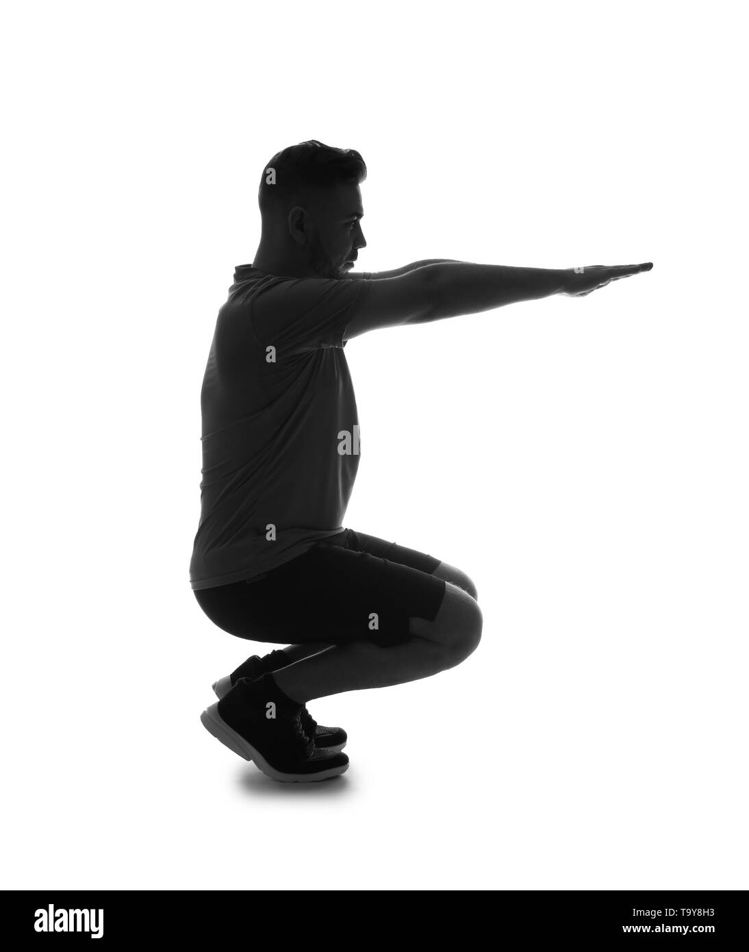 Silhouette der sportlichen Mann eine hockt auf weißem Hintergrund Stockfoto