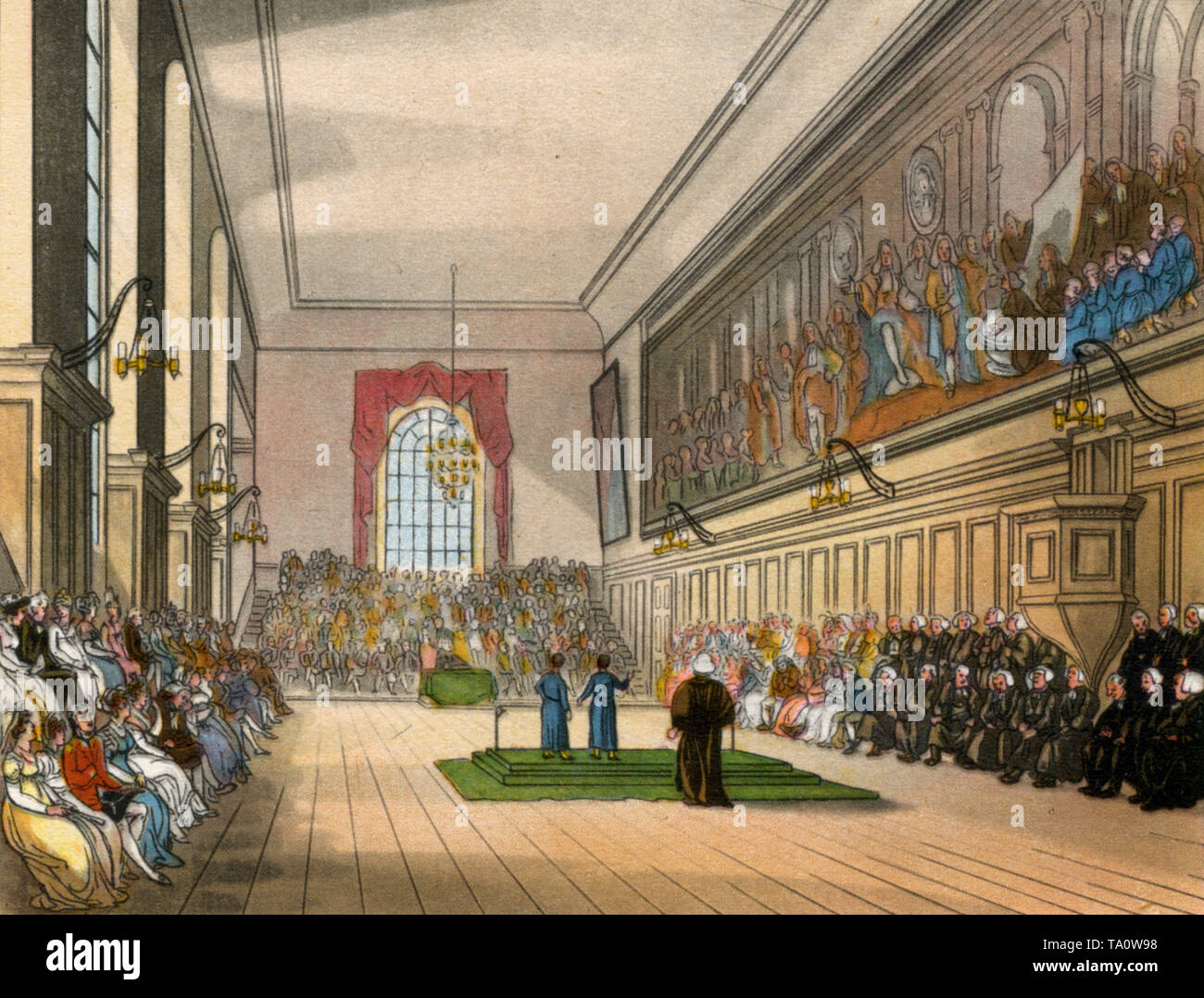 The Hall, Christ's Hospital (Bluecoat School), c1808-1810. Ein Druck aus dem 'Mikrokosmos von London', von William Henry Pyne (1770-1843). Künstler: Thomas Rowlandson (1756-1827) und Auguste Charles Pugin. Gesehen hier am St. Matthew's Day, 21.. September. Rechts im Bild ist ein imaginiertes Gemälde von James II. Und seinem Hof an der Bluecoat School von Antonio Verrio (c1636-1707) zu sehen. Stockfoto