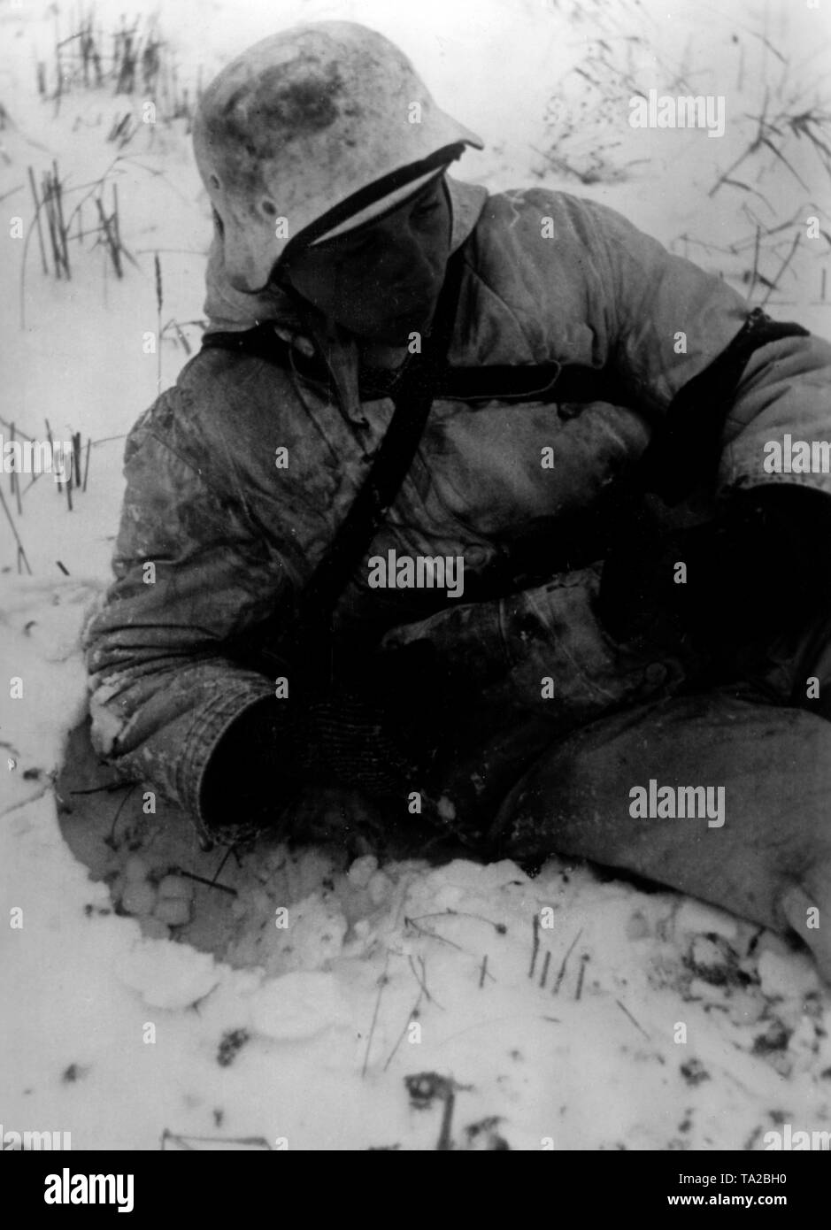Ein deutscher Soldat tragen Winter camouflage liegt im Schnee südöstlich der Stadt Toropez. Foto der Propaganda Firma (PK): SS Kriegsberichterstatter Tufts. Stockfoto