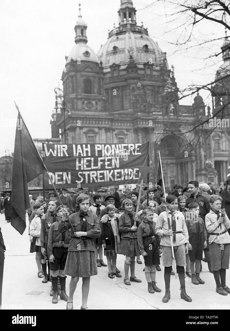 Die jungen Mitglieder der Kommunistischen Partei Deutschlands (KPD), marschieren an der Vorderseite von einer Demonstration Prozession, solidarise mit der streikenden Arbeiter, indem es ein Banner mit der Aufschrift "Wir IAH (International Arbeitnehmer Beihilfen) Pioniere der Streikenden helfen. Stockfoto