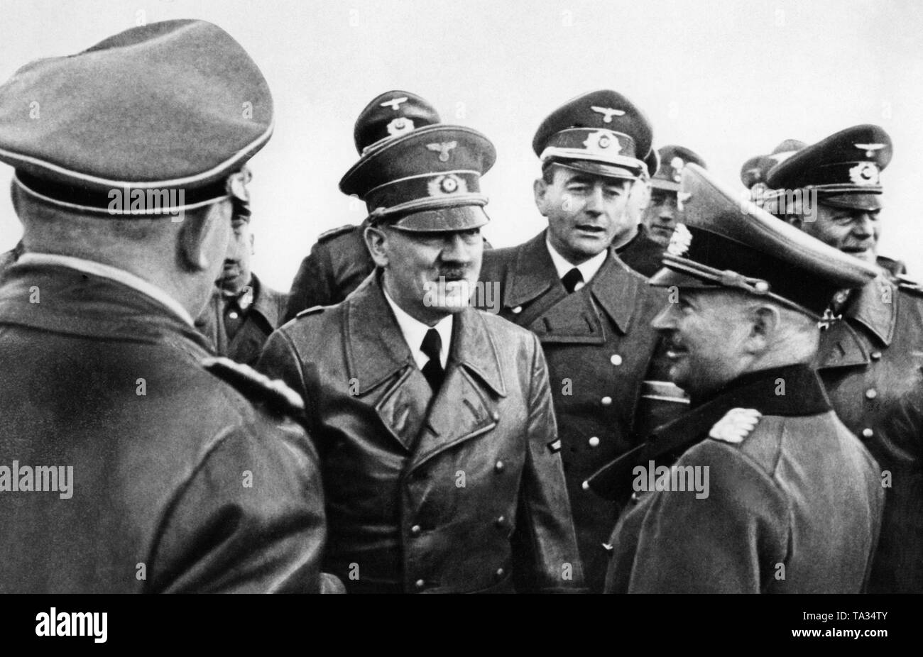 Adolf Hitler bei einer militärischen Demonstration im Gespräch mit dem Generalstabschef der Armee, General Kurt Zeitzler. Zwischen den beiden im Hintergrund des Reichsministers für Rüstung und Kriegsproduktion, Albert Speer. Stockfoto