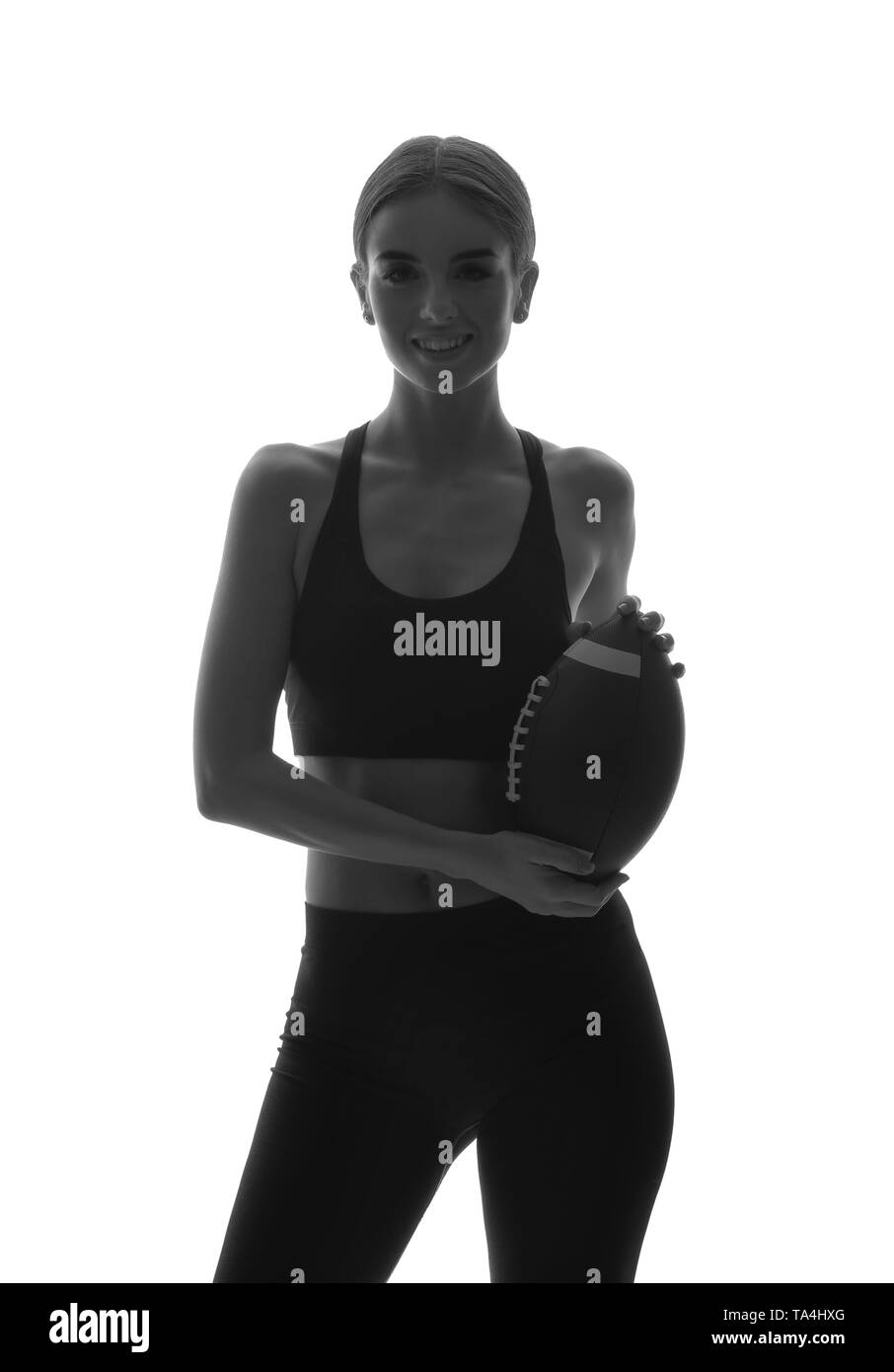 Portrait von sportliche Frau mit Rugby Ball auf weißem Hintergrund Stockfoto