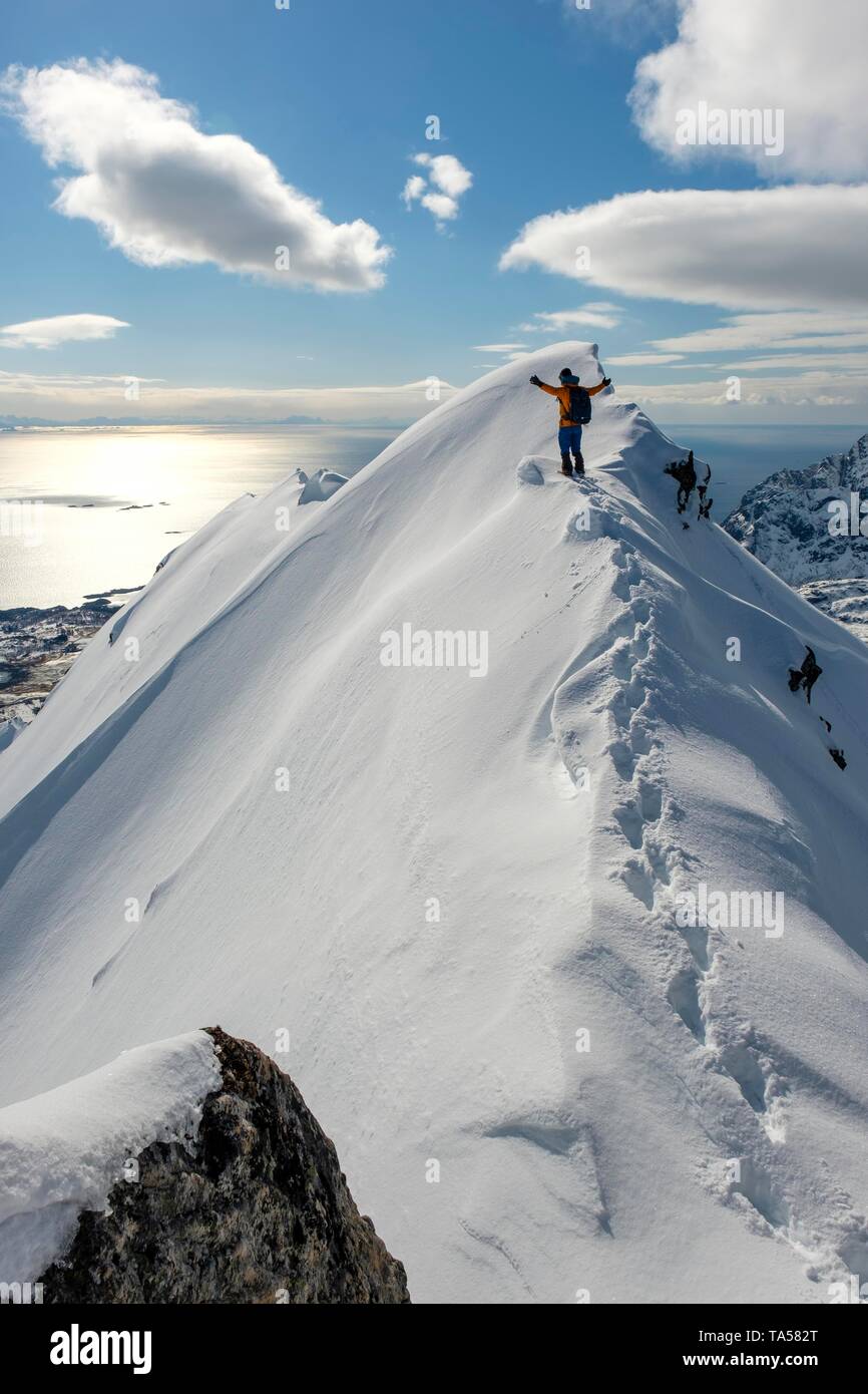 Bergsteiger im Schnee auf dem Kamm des Stortinden, Svolvaer, Austvagoy, Lofoten, Norwegen Stockfoto