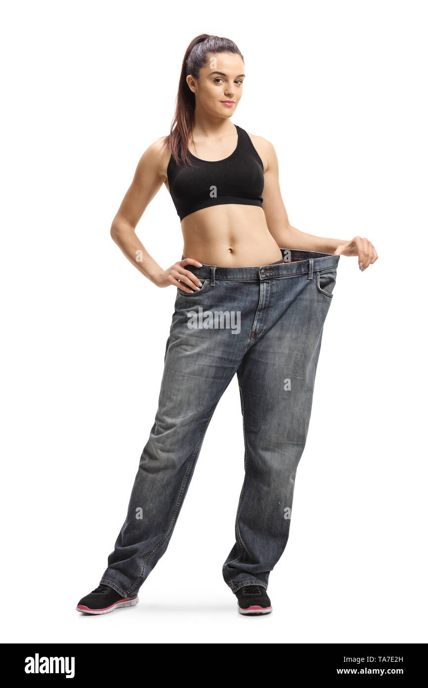 In voller Länge Porträt einer jungen schlanken Frau tragen altes Paar big size Jeans auf weißem Hintergrund Stockfoto