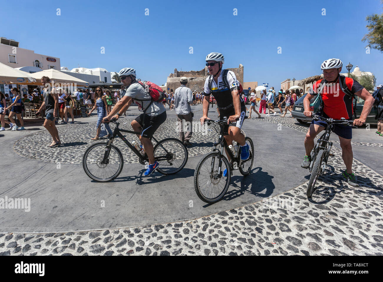 Oia Santorini Touristen Radfahren auf Fahrräder Griechische Insel Griechenland Europa Menschen Stockfoto
