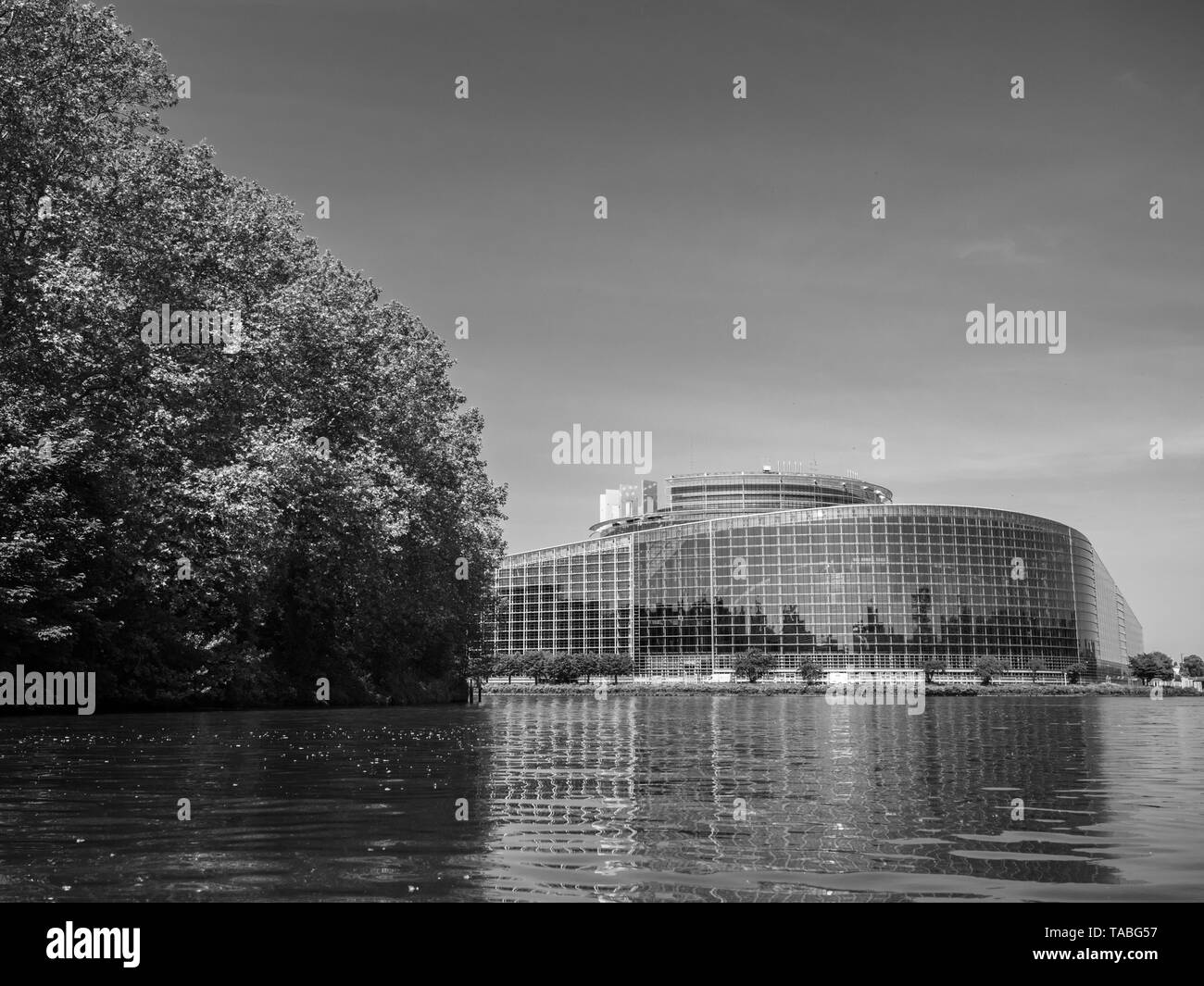 Breite Fassade Hauptsitz des Europäischen Parlaments in Straßburg einen Tag vor 2019 zu den Wahlen zum Europäischen Parlament - klaren Himmel und ruhige Ill Wasser - Schwarz/Weiß-Bild Stockfoto