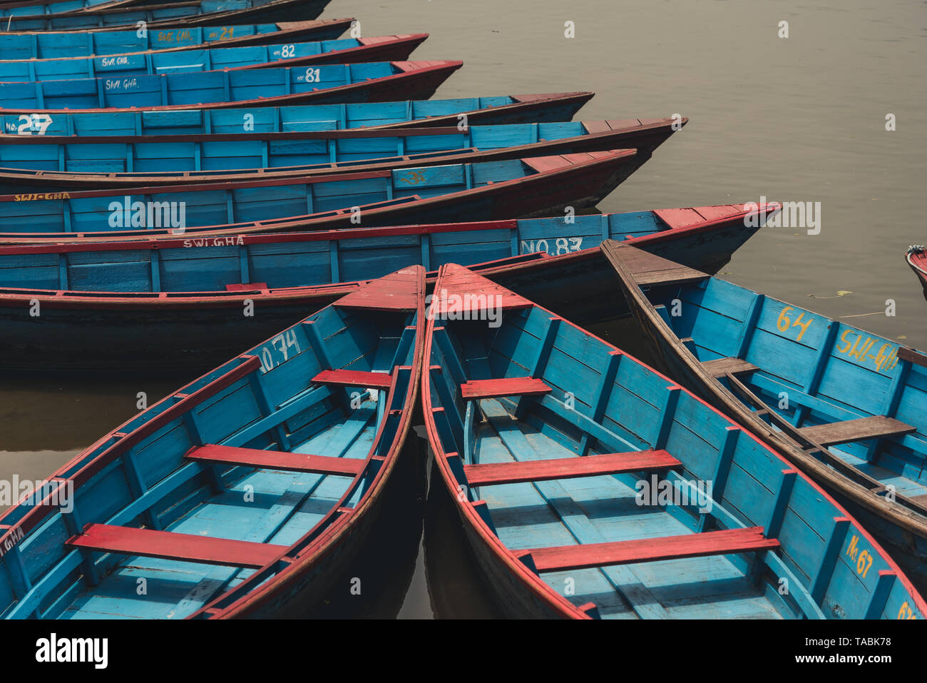 Hohen winkel Blick auf viele rote und blaue Zeile Boote an einem Dock. Stockfoto