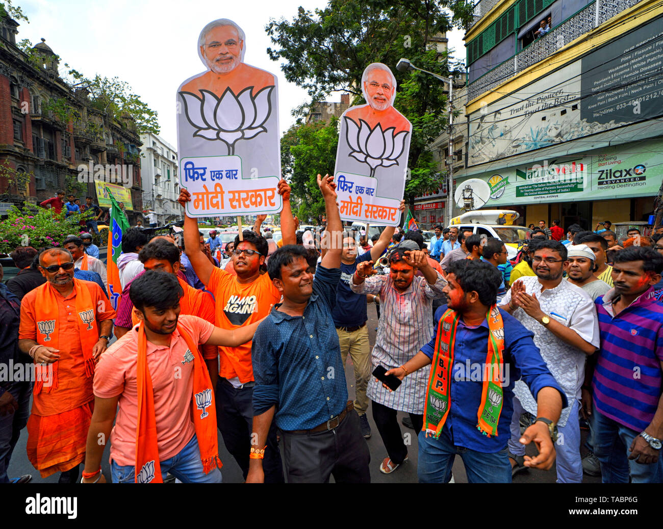 Anhänger der Bharatiya Janata Party (BJP) werden gesehen, Feiern, während sie Ausschnitte der Ministerpräsident Narendra Modi vor der Partei Hauptsitz in Kalkutta nach massiven Gewinnen in Westbengalen & Indien Wahl. Bharatiya Janata Party (BJP) gewinnt Wahl in Kalkutta, Indien. Stockfoto