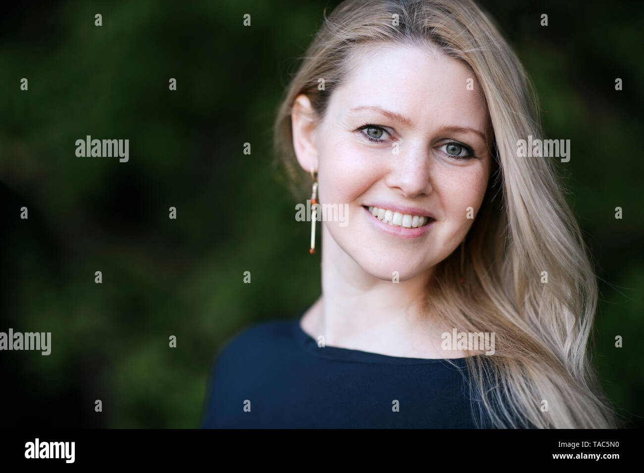 Porträt von lächelnden blonden Frau im freien Stockfoto