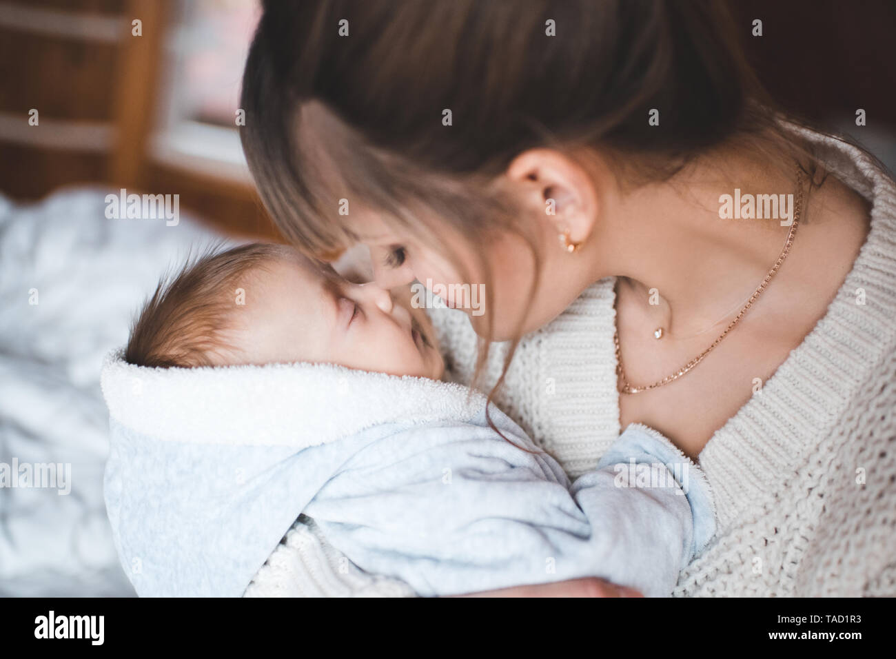Happy Mother Holding schlafendes Baby im Zimmer Nahaufnahme. Die Mutterschaft. Mutterschaft. Stockfoto