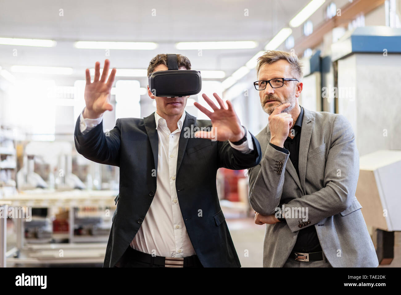 Zwei Geschäftsleute mit VR-Brille in der Factory Stockfoto