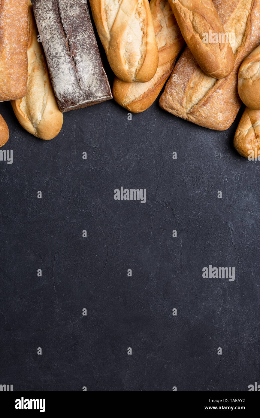 Frische verschiedene Art von Brot auf dunklen Kammer, Ansicht von oben mit der Kopie. Konzept der Banner Stockfoto