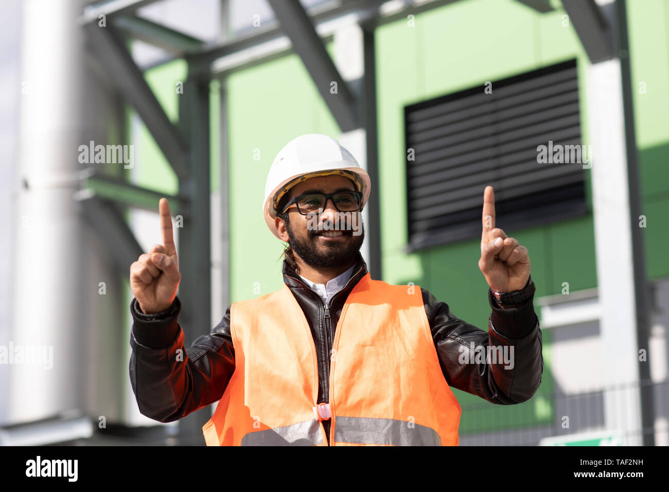Portrait von Bauingenieur vor Power Station das Tragen von Helm und Warnweste Stockfoto