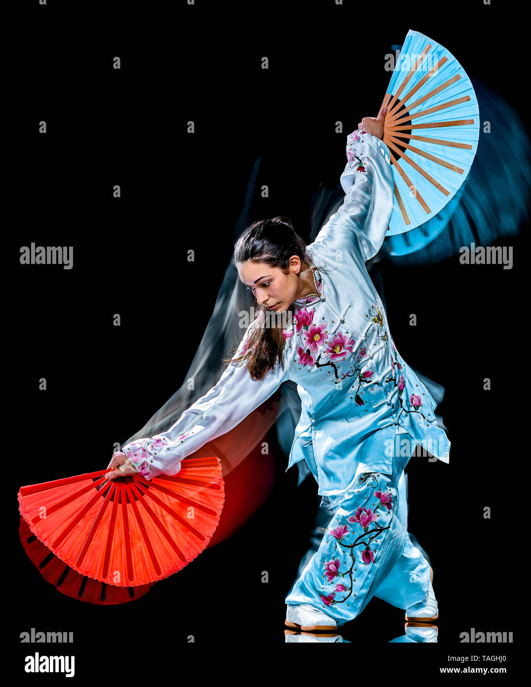 Eine chinesische Frau partacticing Tai Chi Chuan Tadjiquan Körperhaltung studio Schuß auf schwarzen Hintergrund mit Licht malen Effekt isoliert Stockfoto