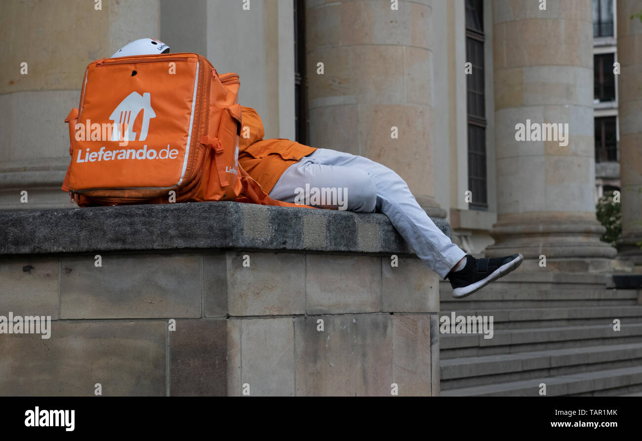 Berlin, Deutschland. 05 Mai, 2019. Ein Mitarbeiter des Zustelldienstes Lieferando auf einem Betonsockel am Gendarmenmarkt liegt und ruht. Credit: Paul Zinken/dpa/Alamy leben Nachrichten Stockfoto