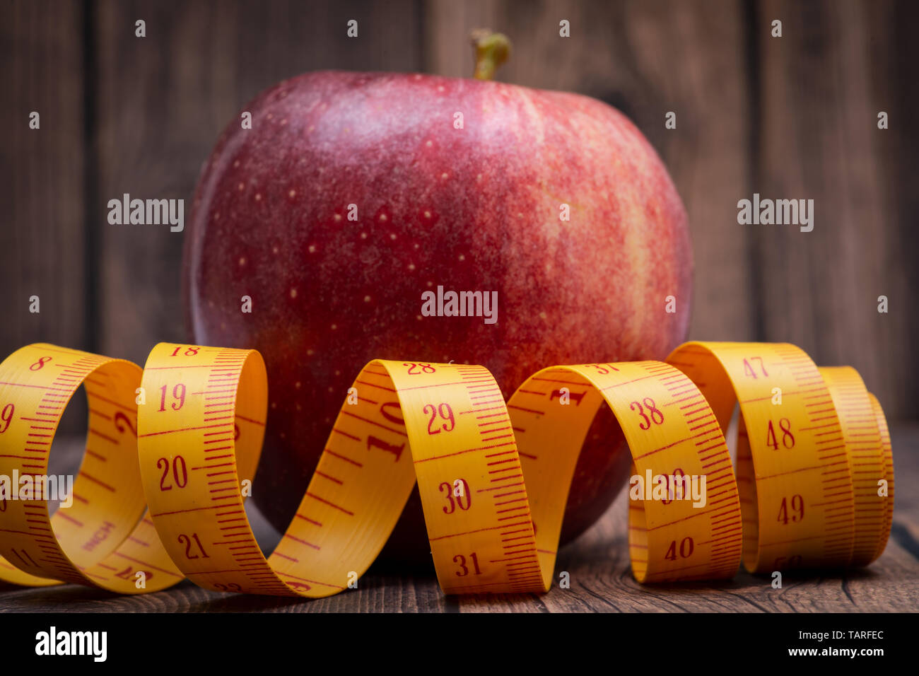 Red Apple und weiches Vinyl Maßband auf Holz- Hintergrund. Stockfoto