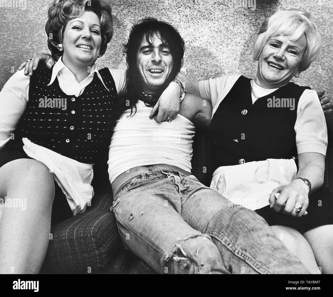 Amsterdam, Holland: Alice Cooper stellte mit zwei Frauen in seinem Hotelzimmer in Amsterdam, Niederlande, 1974 (Foto von Gijsbert Hanekroot) Stockfoto