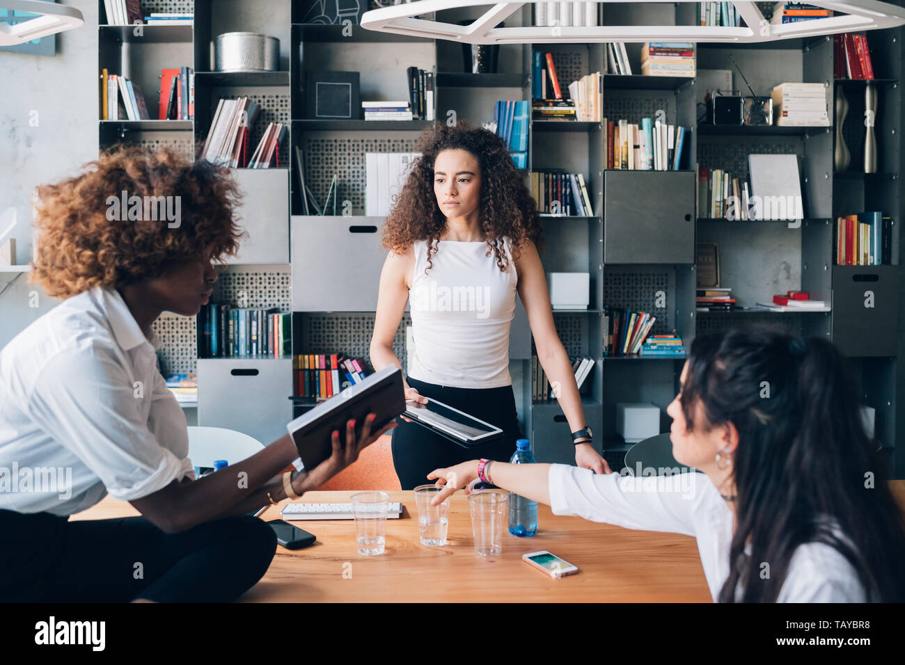 Drei junge multikulturellen Studenten mit Treffen im modernen Büro - Einfallsreich, freiberuflich, Widmung Stockfoto