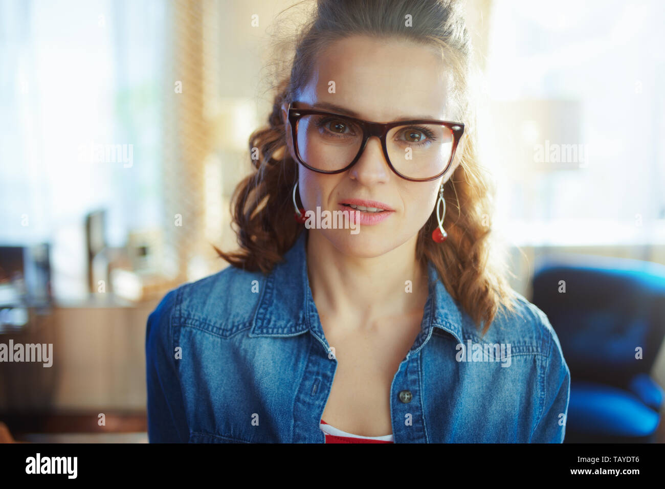 Porträt der jungen Frau in der modernen Wohnzimmer im sonnigen Sommertag. Stockfoto