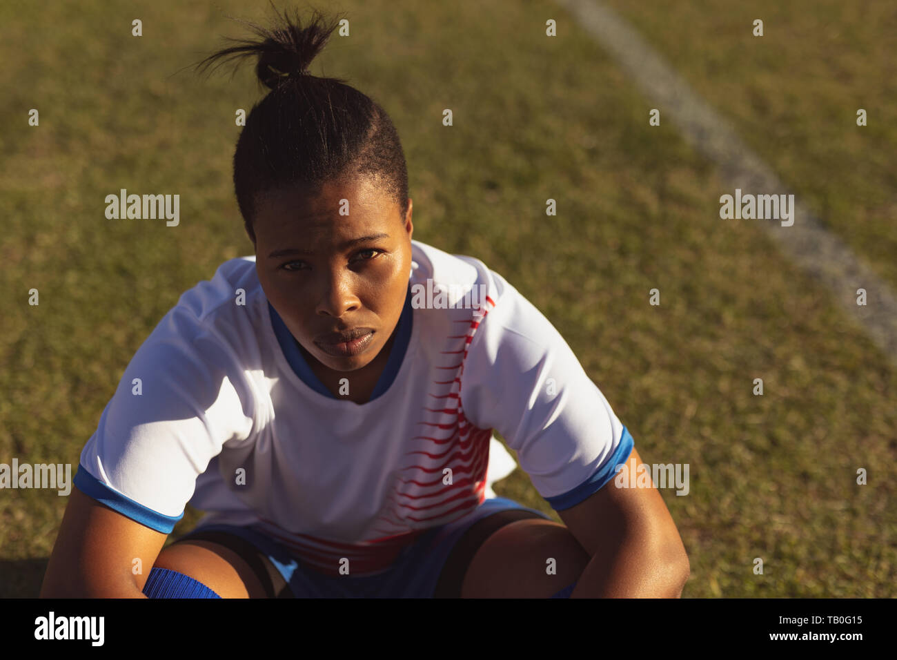 Erschöpft Fußball-Spieler sitzen auf dem Feld nach dem Training Stockfoto