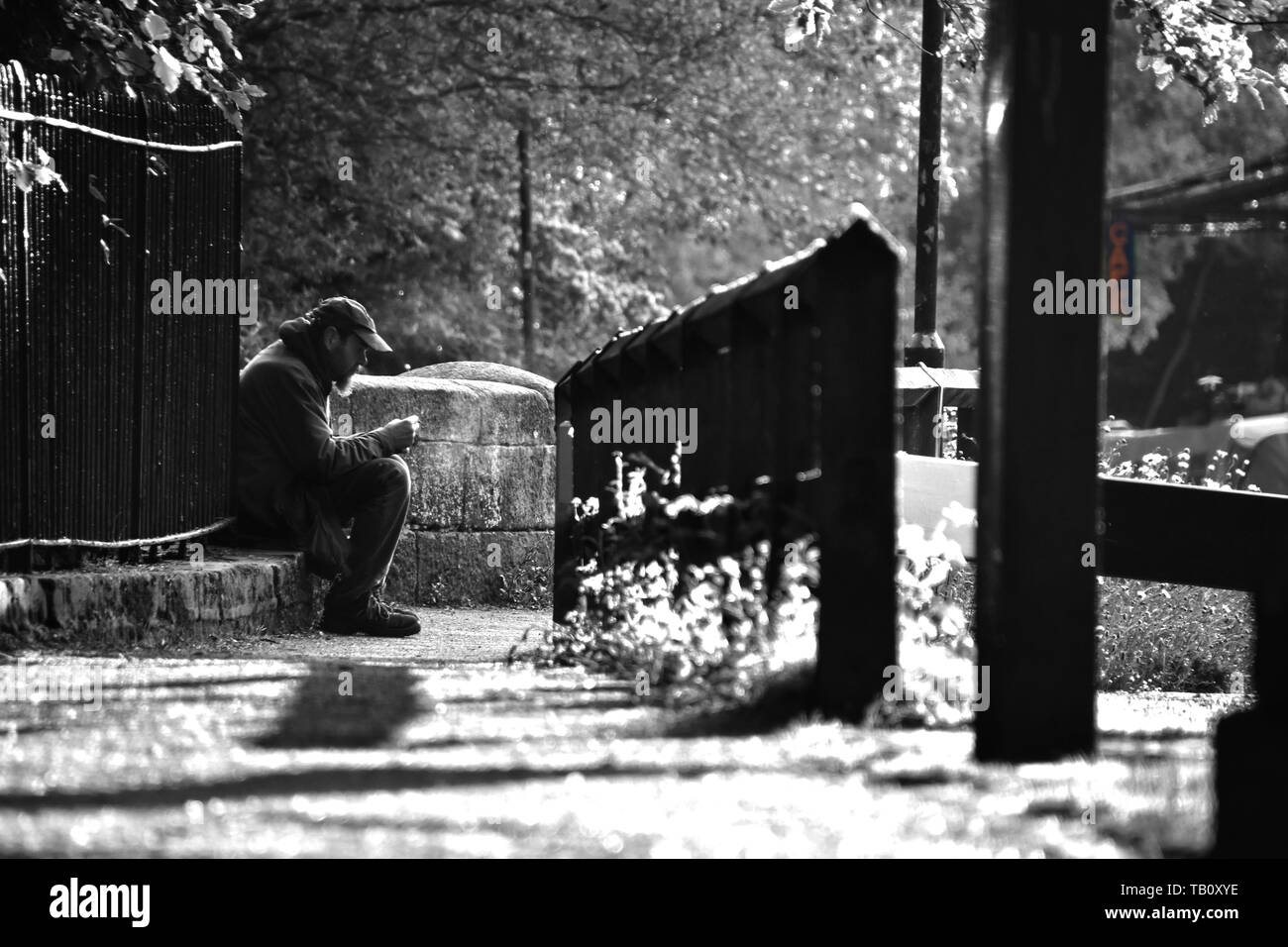 Mann sitzt von Canal in ruhiger Kontemplation, in einen Rauch Stockfoto