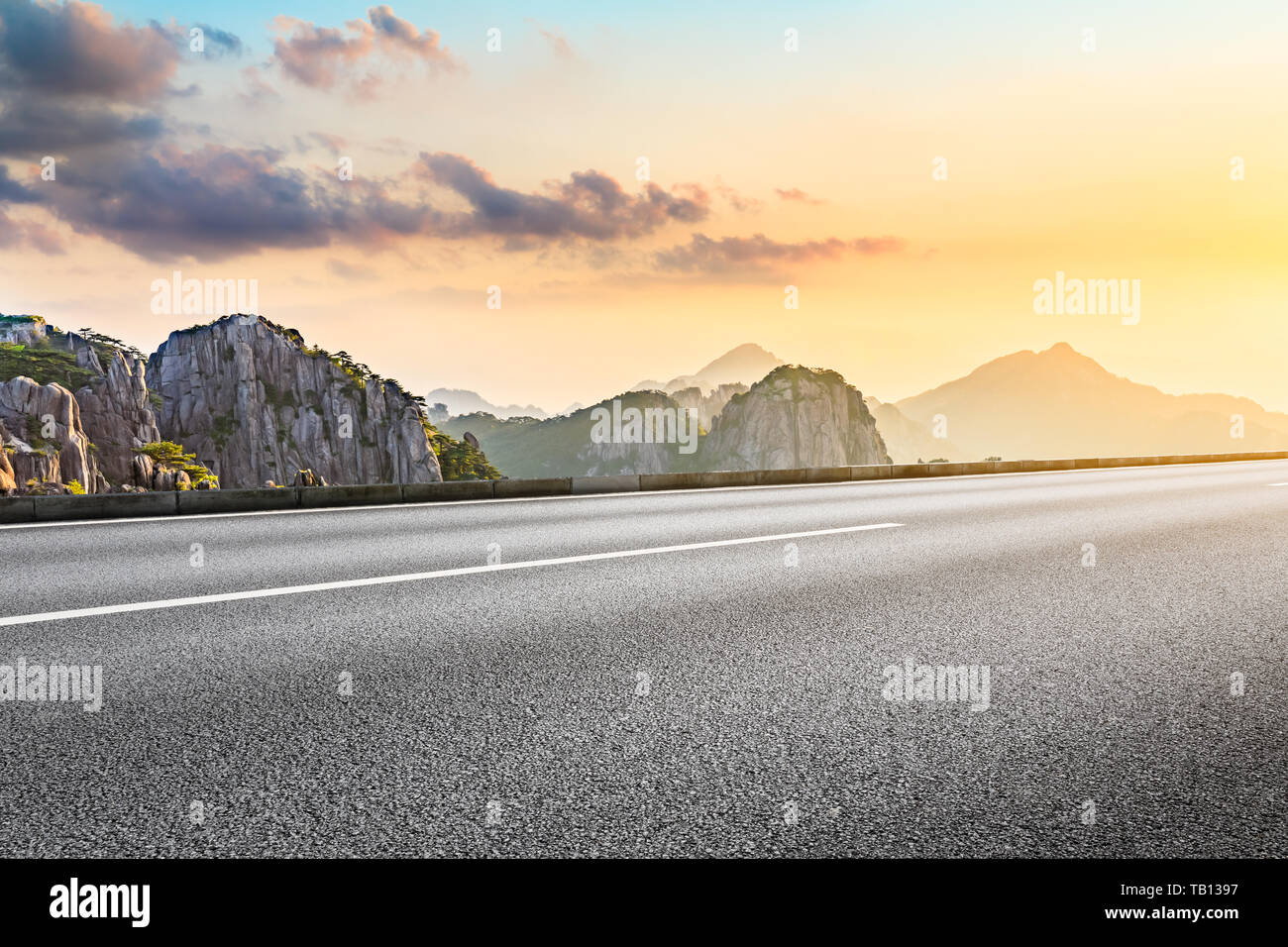 Asphalt Autobahn Straße und schöne huangshan Berge Natur Landschaft bei Sonnenaufgang Stockfoto