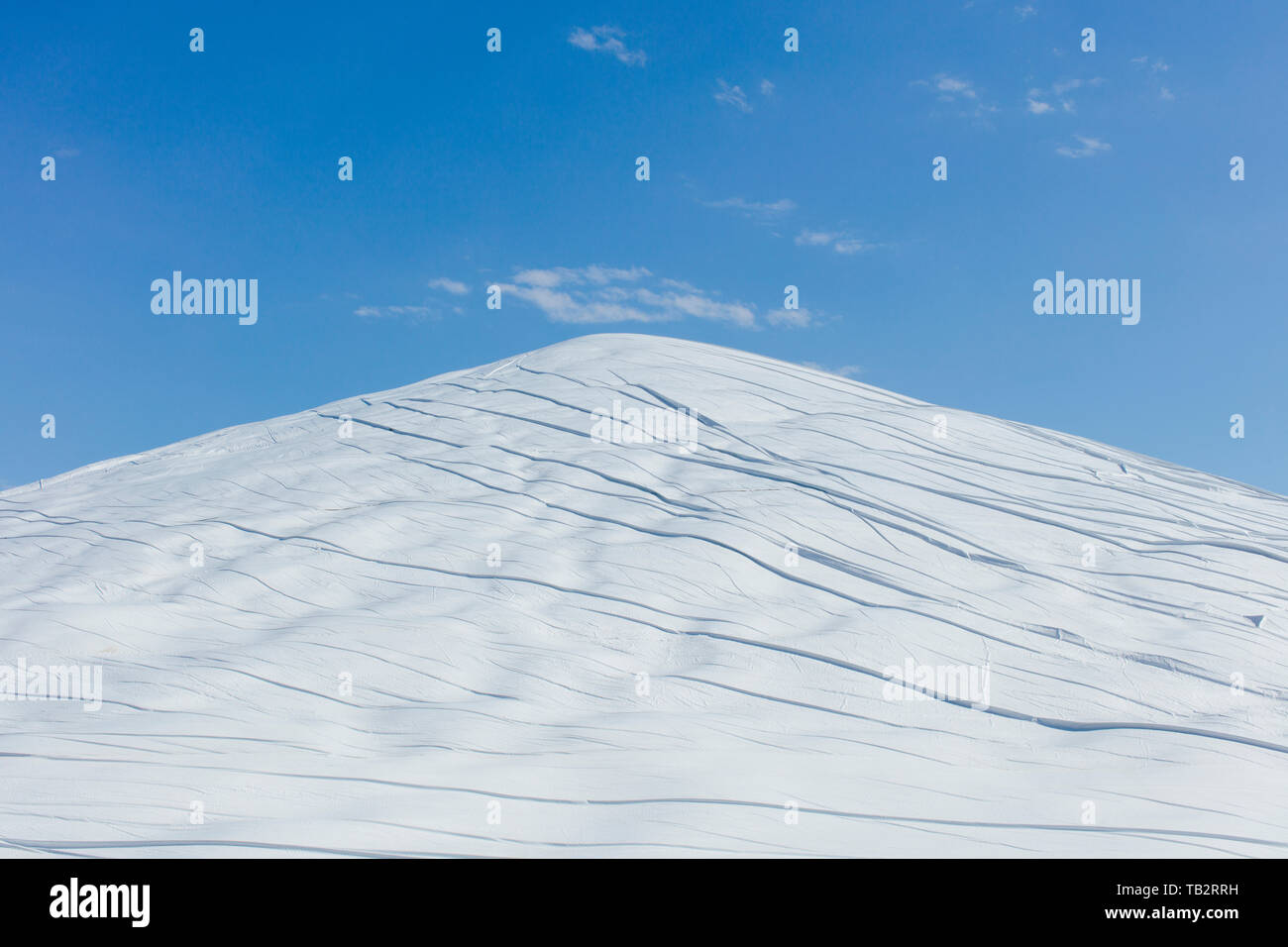 Dung heap bedeckt mit weißen Plane, vor blauem Himmel. Stockfoto
