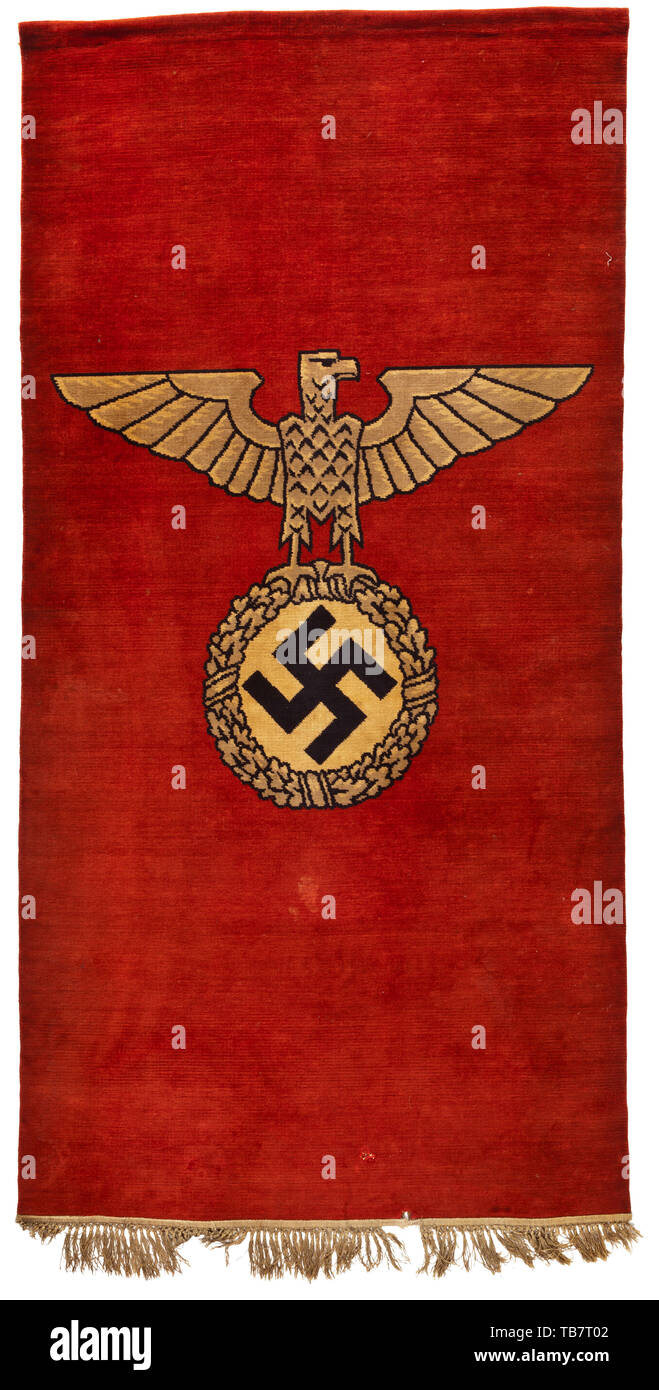 Ein Wandteppich mit nationalen Adler, Wein - Roter Teppich Stoff mit nationalen Eagle (Blick nach rechts) in der frühen Form der Allgemeinen SS in der Mitte. Die oberseite mit genähte Kante eine Fahnenstange, die unteren mit Fransen, mehrere Barren fehlt. Im Gegenteil verstärkt mit Verrechnung. Am unteren Löcher von ca. 2 cm. Teppich, ohne Beschriftung, ohne Maker's Inschrift. Abmessungen 220 x 107 x 1 cm. historischen, historischen des 20. Jahrhunderts, Editorial-Use - Nur Stockfoto