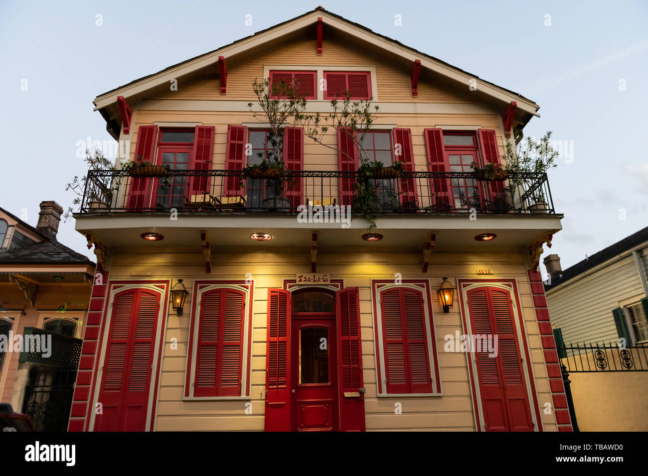 New Orleans, USA - 22. April 2018: Haus auf der Straße in Louisiana berühmten Stadt Stadt bei Nacht am Abend mit traditionellen Gusseisen und roten Architektur Stockfoto
