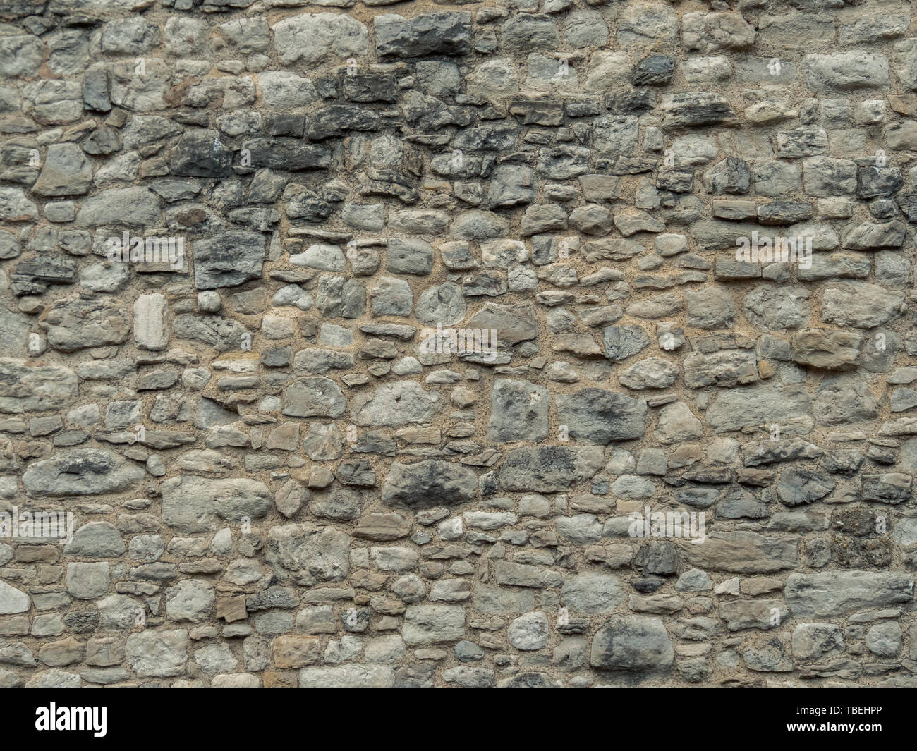 Textur einer Steinmauer. Alte Burg Stein Wand Textur Hintergrund. Stein Wand als Hintergrund oder Textur. Teil einer Mauer aus Stein, für den Hintergrund oder Text Stockfoto