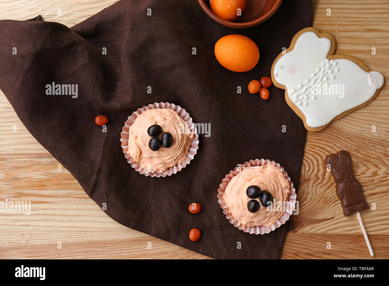 Lecker Ostern Cupcakes mit Süßigkeiten auf hölzernen Tisch Stockfoto