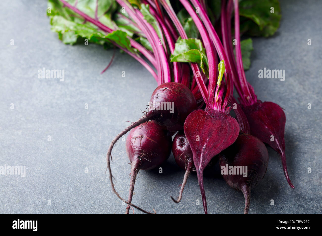 Frische organische Rüben, rote Beete. Grauer Hintergrund. Kopieren Sie Platz. Ansicht von oben. Stockfoto