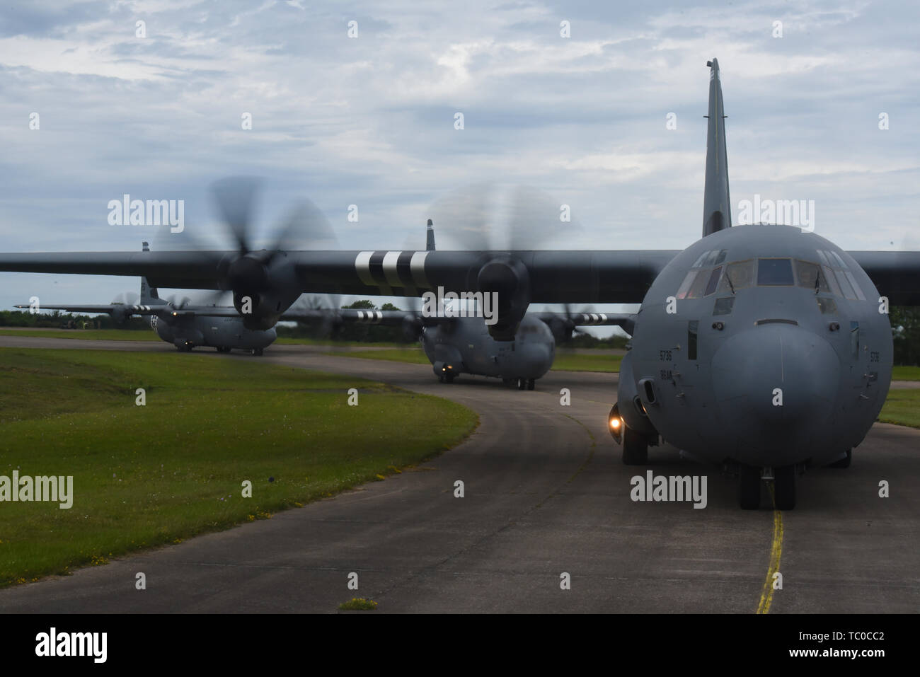 Drei Super C-130J Hercules, der 37Th Airlift Squadron auf der Air Base Ramstein, Deutschland, zur Startbahn rollen zugewiesen, bevor Sie die Einnahme und die Teilnahme an einer Ausbildung praxis Flug in der Nähe von Cherbourg, Frankreich, 2. Juni 2019. Während der zweiten Hälfte der Formation die Leitung C-130J, geflogen von Oberstleutnant Alex Miller, 37. als Chief Pilot, und Kapitän Joe Rippe, 37 als Co-pilot, senkte die Rampe eine amerikanische Flagge, wo es in der Wind über die Strände der Normandie winkte anzuzeigen. (U.S. Air Force Foto von älteren Flieger Kristof J. Rixmann) Stockfoto