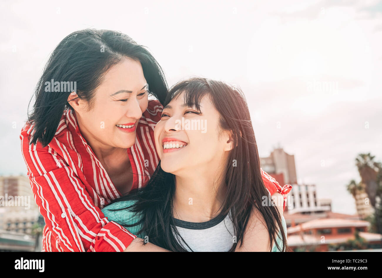 Glückliche Mutter und Tochter Spaß im Freien - asiatische Familie genießen die Zeit zusammen außerhalb - Begriff des Menschen Lifestyle, der Liebe und der Elternschaft Stockfoto