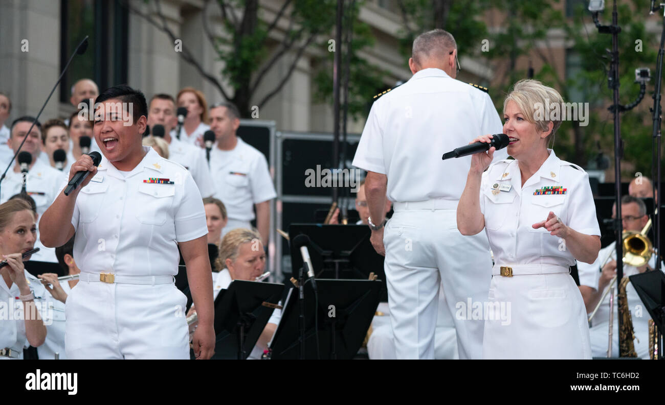 Washington, Vereinigte Staaten von Amerika. 04 Juni, 2019. Musiker 1. Klasse Danlie Cuenca und Vorzusingen Shana Sullivan durchführen. Konzerte der US-Navy Band auf der Avenue Serie, am Dienstag abend um 7:30 Uhr in der US-Navy Memorial in Washington, DC, hielt die erste seiner geplanten Konzerte im Sommer am 4. Juni 2019. Die Marine Band Sea Chanters ist offizieller Chorus der United States Navy. (Foto von Jeff Malet) Foto per Kreditkarte: Newscom/Alamy leben Nachrichten Stockfoto