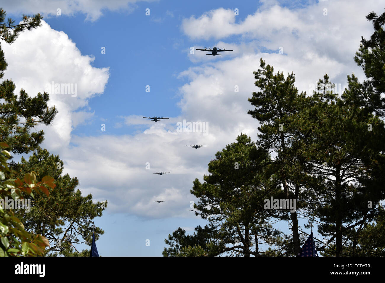 Us-amerikanische und französische Militärflugzeuge multiple flyover Demonstrationen während der Feier des 75. Jahrestages der D-Day in der Normandie amerikanische Friedhof und Denkmal, 6. Juni 2019. Die Zeremonie ist die Spitze von mehr als 80 Veranstaltungen zum Gedenken an den 75. Jahrestag des D-Day, dem größten multi-nationalen amphibische Landung und operativen militärischen Airdrop in der Geschichte und markiert den USA unerschütterliches Engagement für den europäischen Verbündeten und Partnern. Mehr als 1.300 US-service Mitglieder mit 950 Soldaten aus ganz Europa und Kanada zusammen, im Nordwesten von Frankreich zu konvergieren Stockfoto