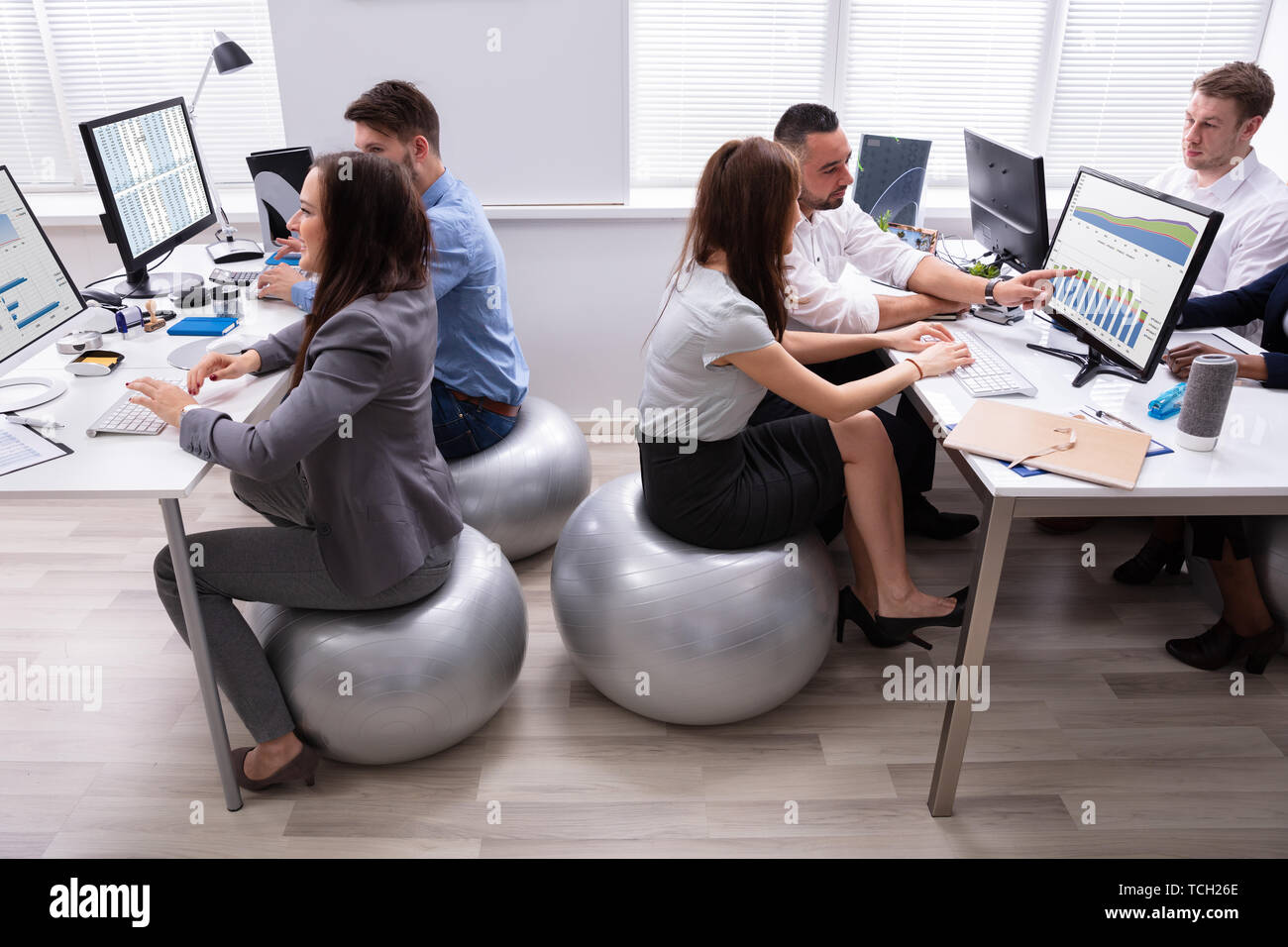 Woman At Desk Fitness Ball Stockfotos Woman At Desk Fitness Ball