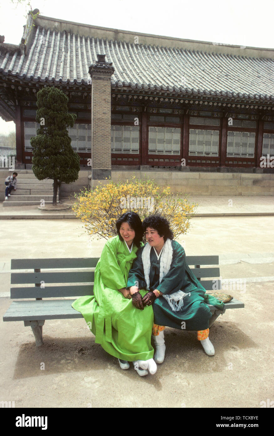 SEOUL KOREA twoi Mädchen in traditioneller Kleidung auf einer Bank im Garten des Königlichen Palastes Gyeongbokgong Stockfoto