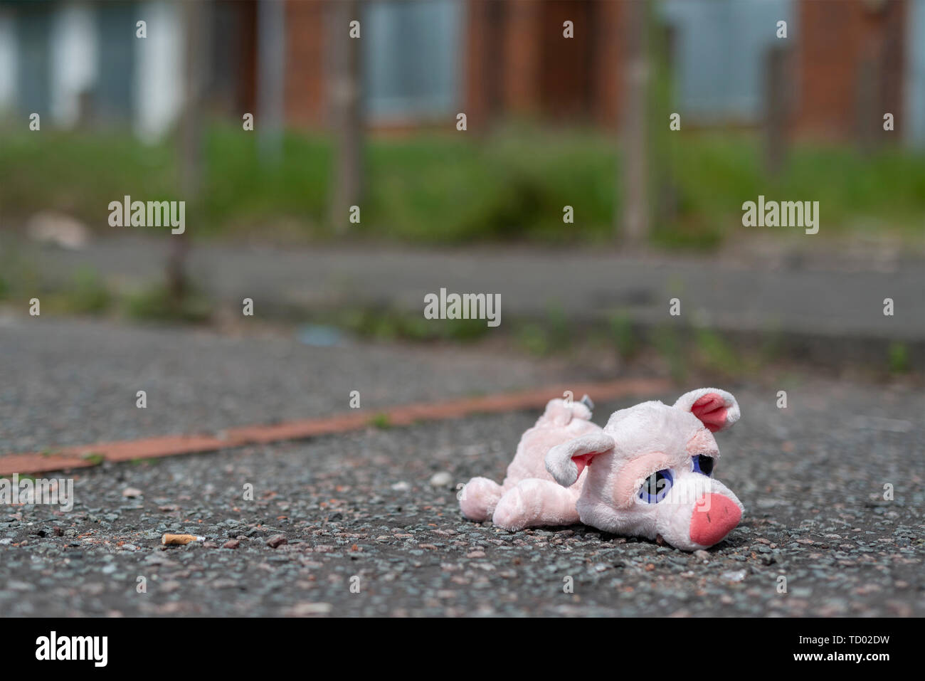 Toy ist ein Kind liegt auf dem Boden außerhalb einige Verbrettert verlassenen Häusern auf der High Street Immobilien in Pendleton, Salford, Greater Manchester, UK. Stockfoto