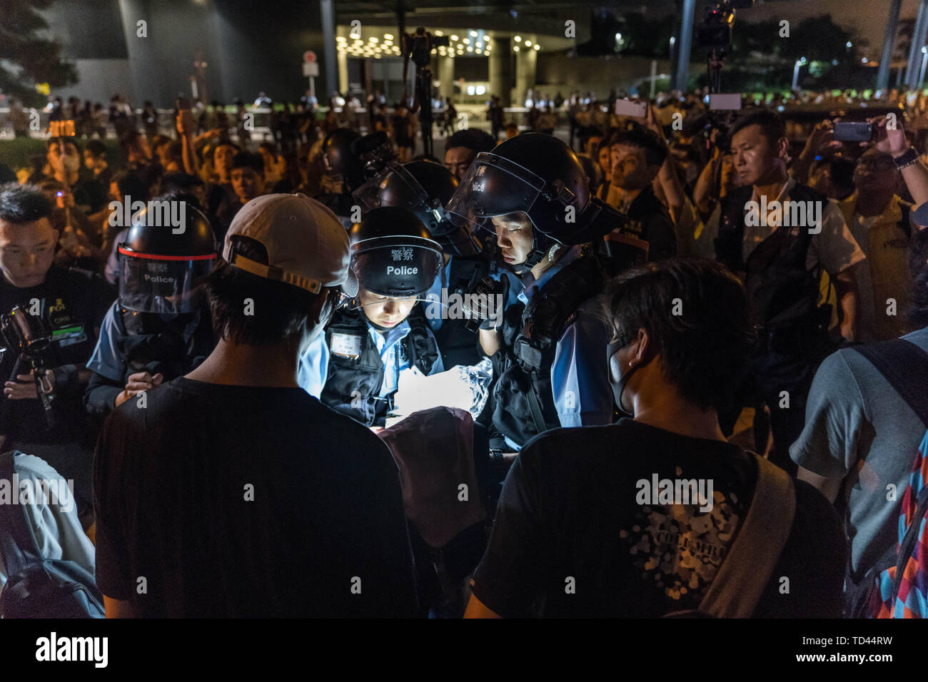 Die Polizei einen Mann außerhalb des Gesetzgebenden Rates Komplex in Hongkong zwei Tage nach dem die Stadt ihren größten Straße Protest in mindestens 15 Jahren gezeugt, als Hunderttausende gegen den Plan der Regierung die Rechnung zu Auslieferungen auf dem Festland China erlauben, marschierten suchen. Die Regierung von Hongkong abgelehnt, eine umstrittene Rechnung zu ermöglichen Auslieferungen auf dem chinesischen Festland, Chief Executive Carrie Lam erklärte, die Gesetzgebung die Rechnung Debatte am 12. Juni würde wie geplant, Ablehnen von Anrufen zu verzögern, das Gesetz zurückzuziehen oder zu verschrotten. Stockfoto