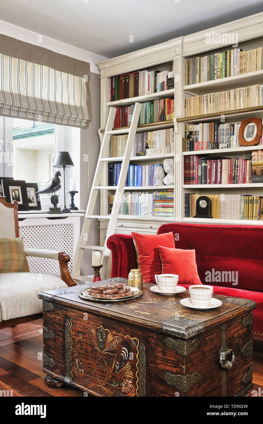 Couchtisch aus Schatztruhe mit Hand geschmiedetem Eisen Hardware vor der roten Sofa im Wohnzimmer britische und irische NUR RECHTE Stockfoto