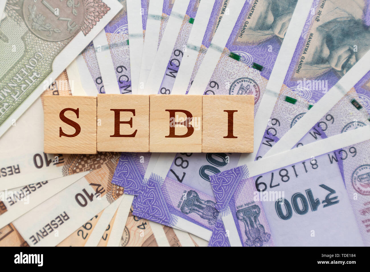 SEBI in Holzblock Buchstaben auf der indischen Währung Stockfoto